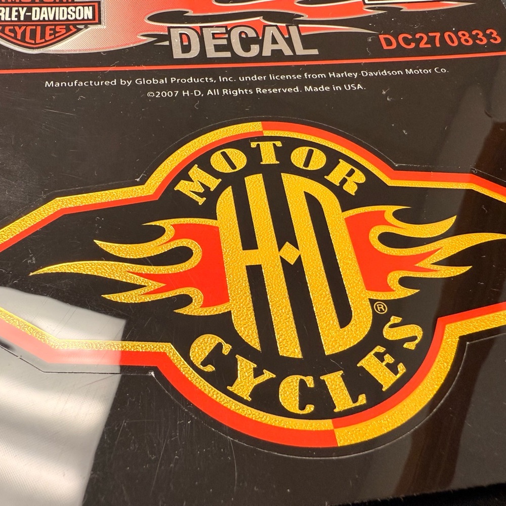 Harley-Davidson® Glossy Flame Logo sticker, with yellow and orange writing.